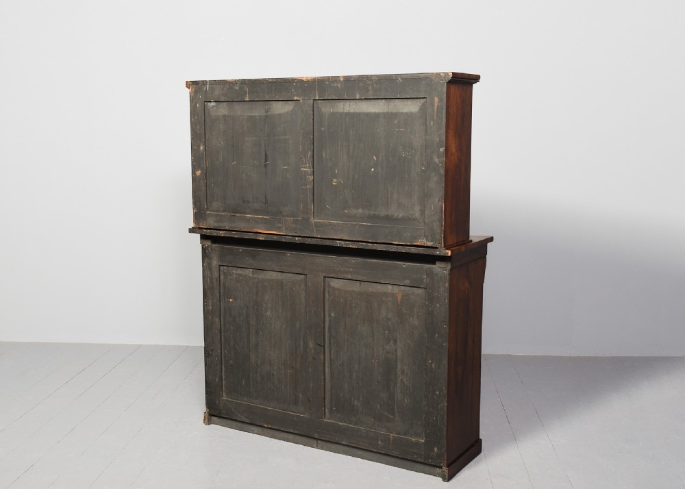 A two-part Regency rosewood bookcase featuring an open upper shelf area above a twin-door lower cupboard with carved corbels. View VIII