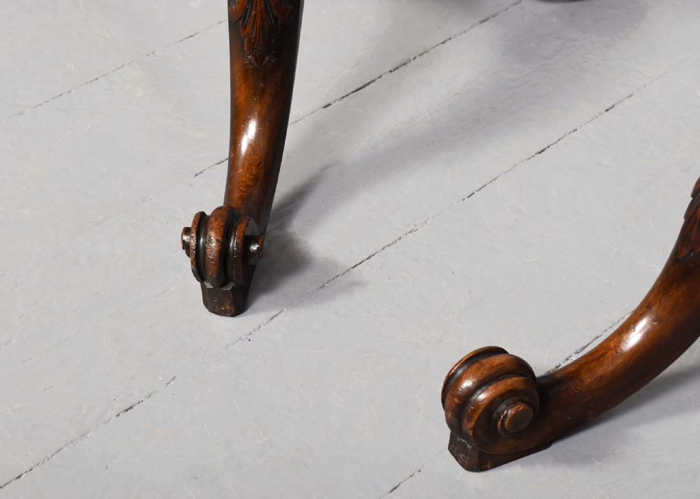 A pair of 19th-century mahogany tripod occasional tables featuring circular tops, carved turned central shafts, and three cabriole legs with scroll feet. View IV