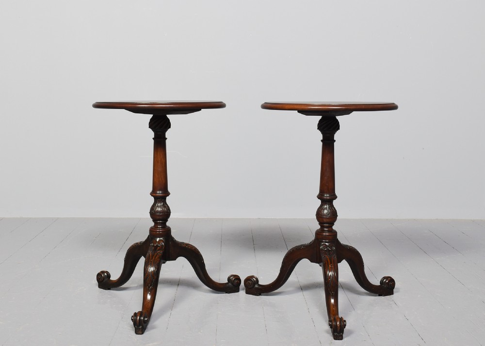 A pair of 19th-century mahogany tripod occasional tables featuring circular tops, carved turned central shafts, and three cabriole legs with scroll feet. View V