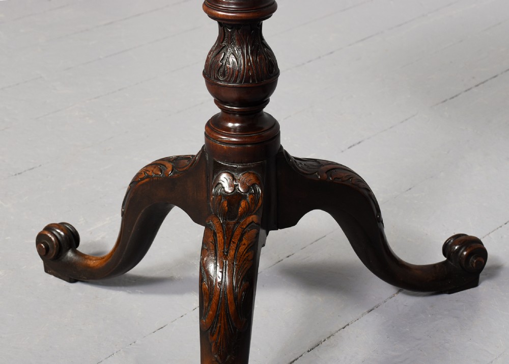 A pair of 19th-century mahogany tripod occasional tables featuring circular tops, carved turned central shafts, and three cabriole legs with scroll feet. View VI