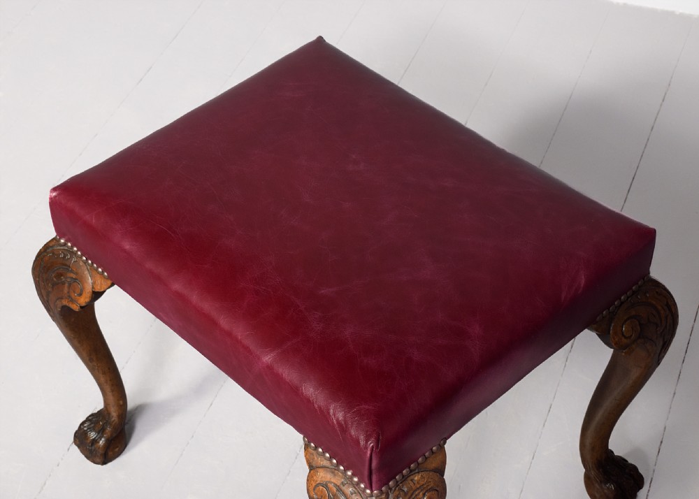 George III style rectangular stool upholstered in a quality burgundy hide with brass studding View II