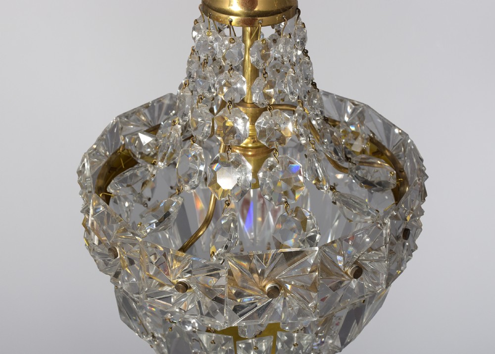 A pair of brass and cut crystal pendant light fittings featuring faceted glass droplets suspended from brass chains. View IV