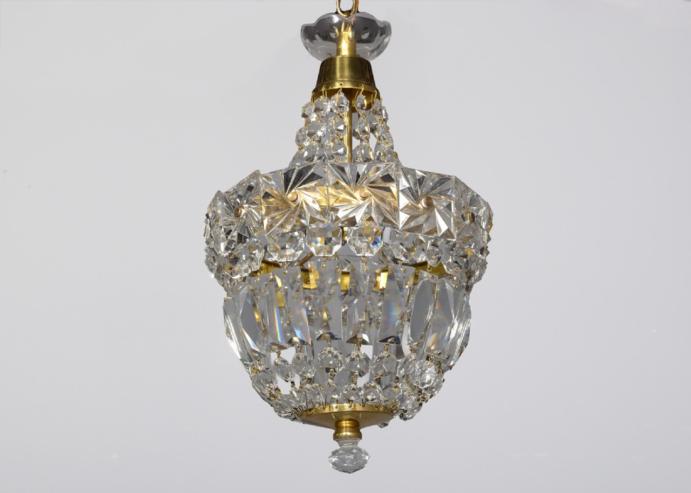 A pair of brass and cut crystal pendant light fittings featuring faceted glass droplets suspended from brass chains. View VII