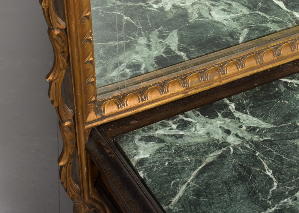 An Italian carved giltwood console table featuring a green marble top and an integrated tall rectangular mirror frame. View II