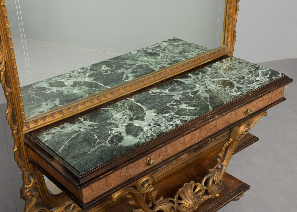 An Italian carved giltwood console table featuring a green marble top and an integrated tall rectangular mirror frame. View V