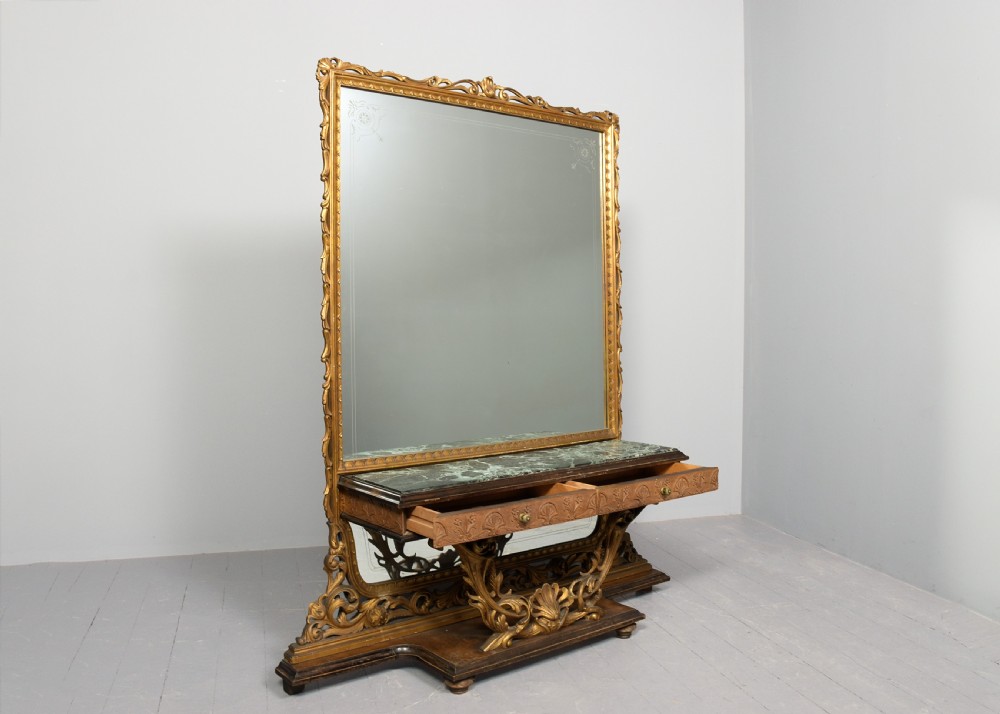 An Italian carved giltwood console table featuring a green marble top and an integrated tall rectangular mirror frame. View VII