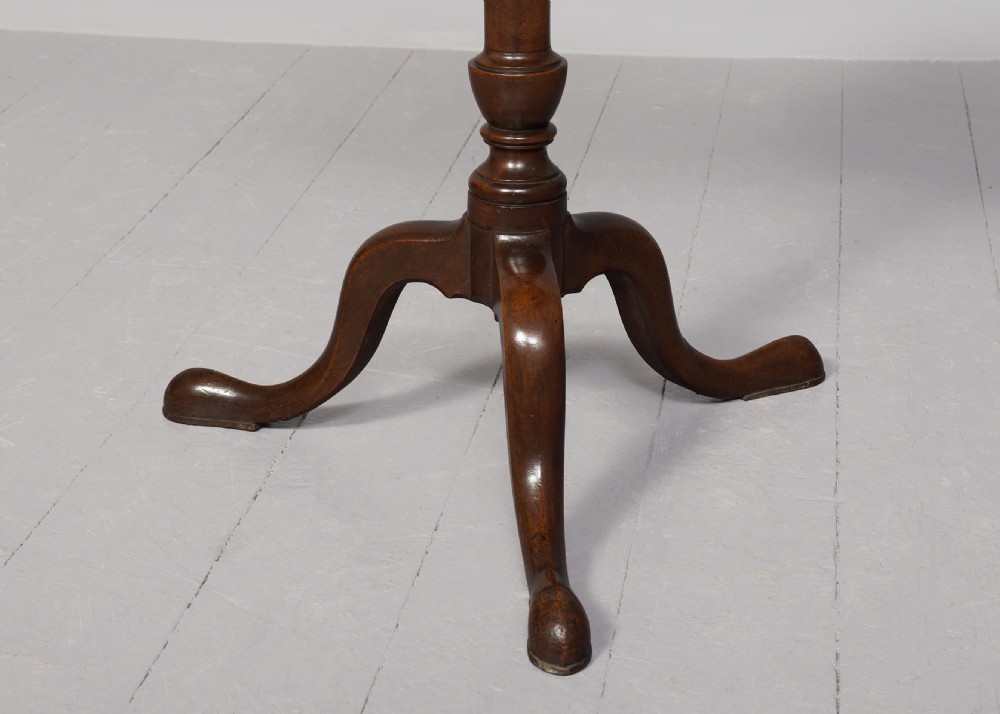 A George III mahogany occasional table featuring an octagonal tray top, turned central column, and a tripod base with cabriole legs. View III