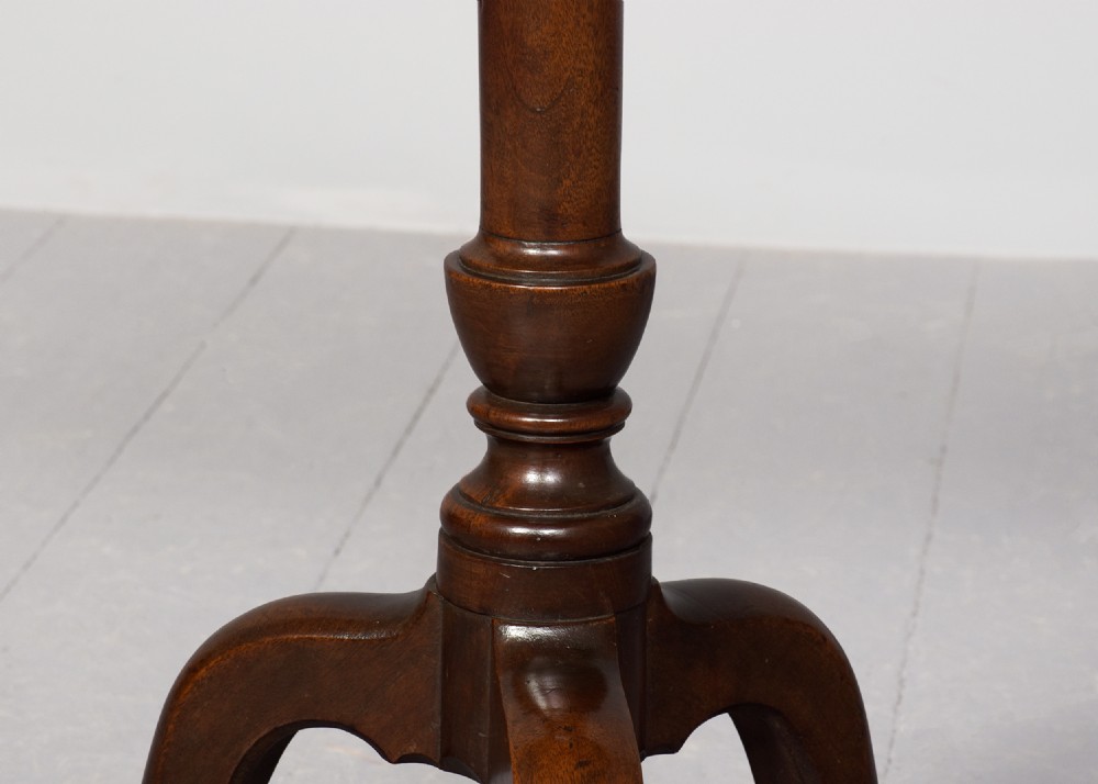 A George III mahogany occasional table featuring an octagonal tray top, turned central column, and a tripod base with cabriole legs. View IV