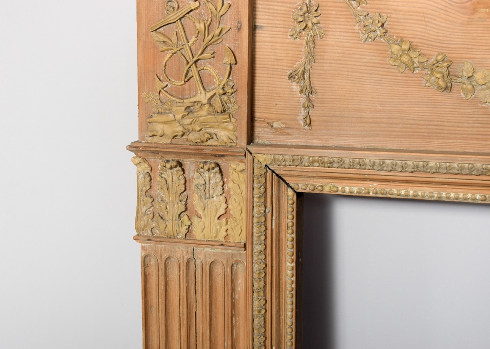 A George III carved pine and gesso mantelpiece featuring fluted pilasters, classical swags, and a central floral garland motif. View III