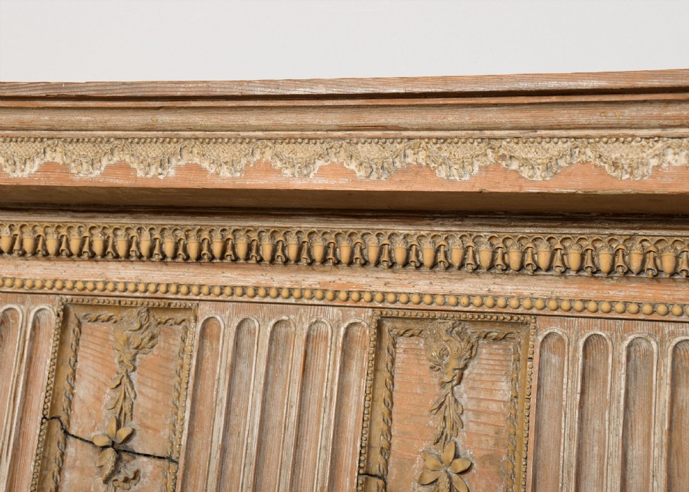 A George III carved pine and gesso fireplace surround featuring fluted jambs, classical urn motifs, and a detailed frieze. View VI