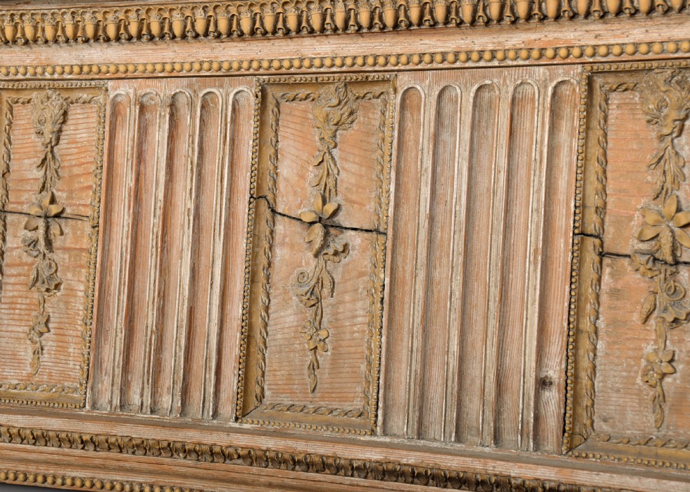A George III carved pine and gesso fireplace surround featuring fluted jambs, classical urn motifs, and a detailed frieze. View IX