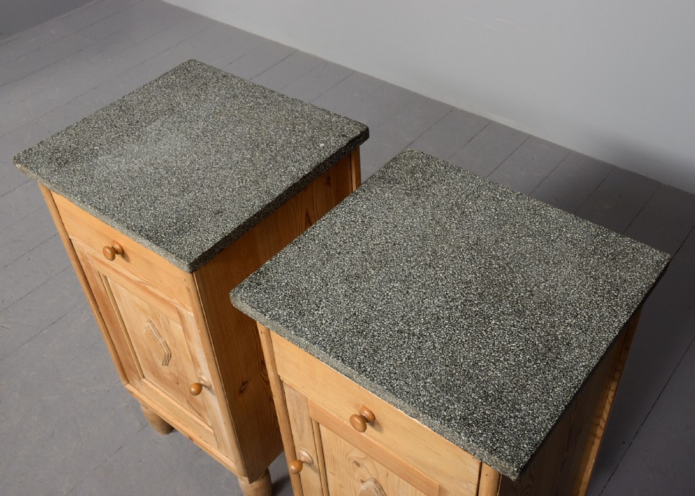 A pair of natural pine bedside cabinets with grey marble tops, single drawers, and diamond carved door panels on turned feet. View IV