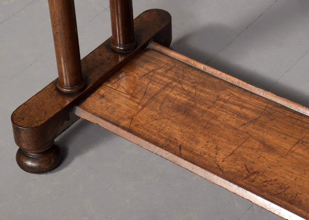 A William IV mahogany side table featuring a low gallery upstand, a long frieze drawer with round wooden knobs, twin turned end supports, a low stretcher, and bun feet. View VIII