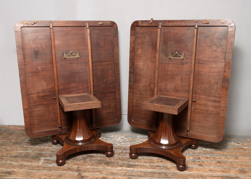 A William IV twin-pedestal dining table crafted from dark figured mahogany with rounded corners and plinth bases on bun feet. View IV
