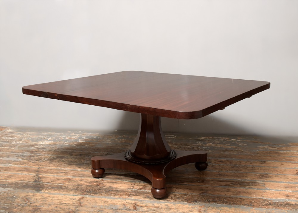 A William IV twin-pedestal dining table crafted from dark figured mahogany with rounded corners and plinth bases on bun feet. View IX