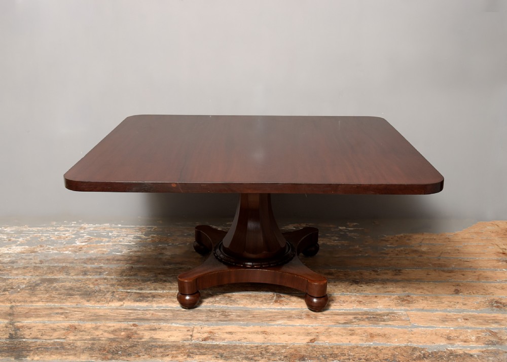 A William IV twin-pedestal dining table crafted from dark figured mahogany with rounded corners and plinth bases on bun feet. View XI