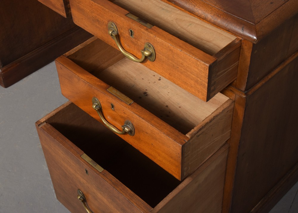 A large Victorian mahogany partners desk with a brown leather inset writing surface, twin pedestals with drawers, and brass swan-neck drop handles. View III