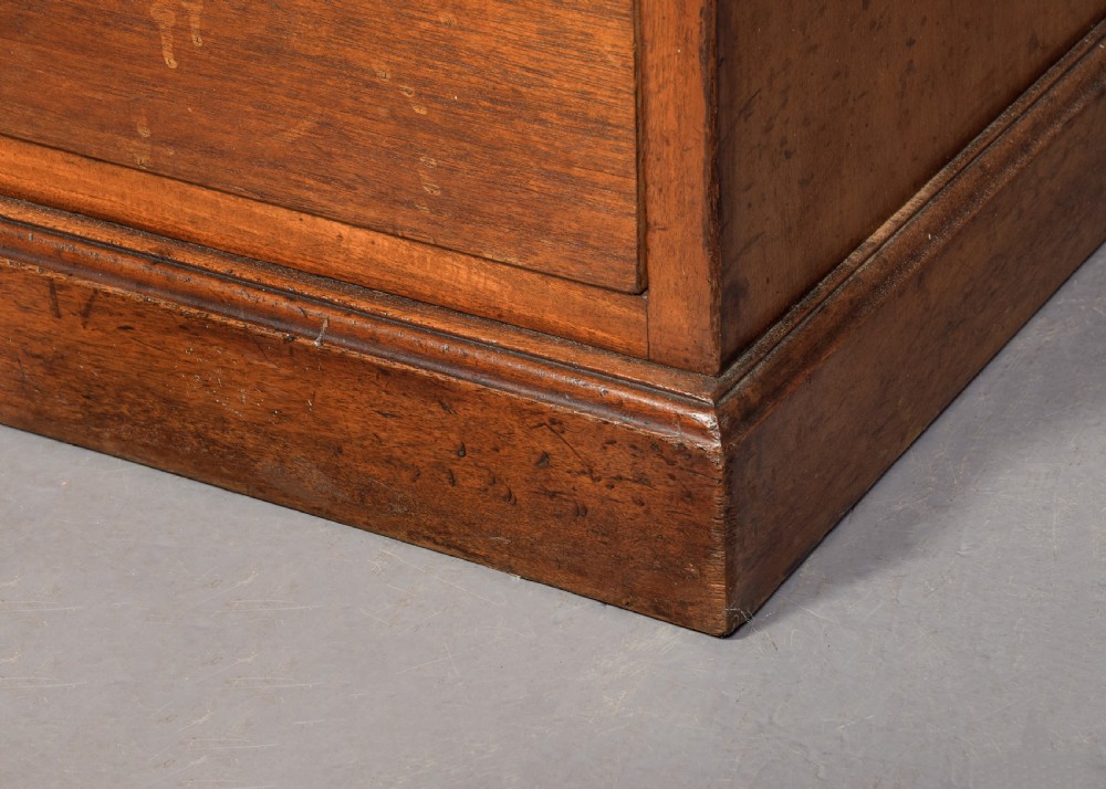 A large Victorian mahogany partners desk with a brown leather inset writing surface, twin pedestals with drawers, and brass swan-neck drop handles. View V