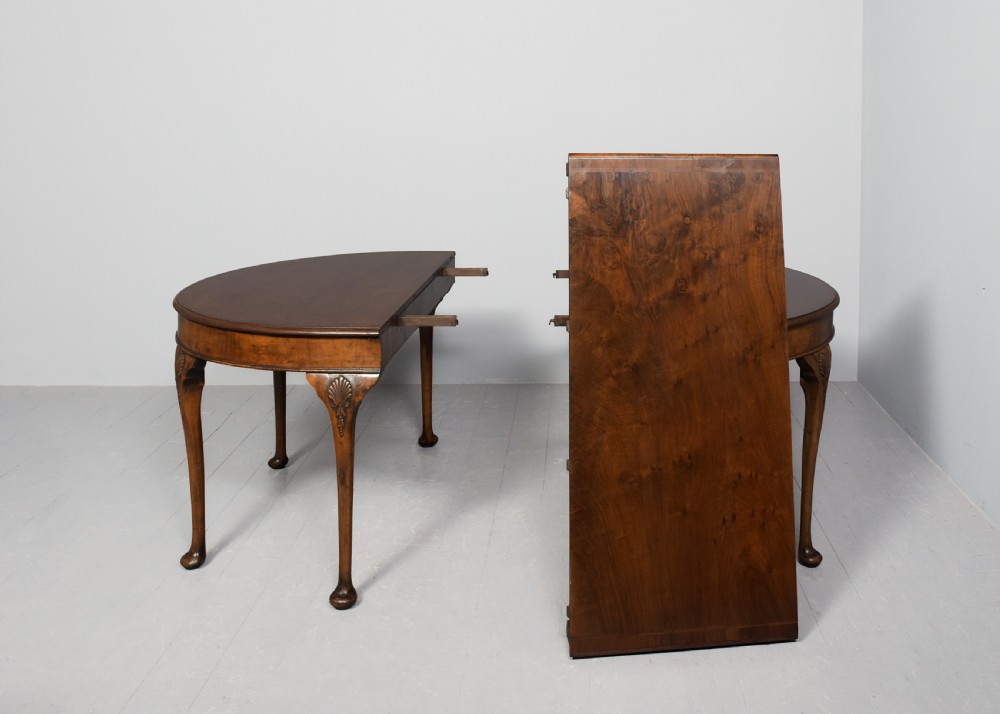 A George II style walnut extending dining table with carved cabriole legs, shell-detailed knees, and pad feet. View VII
