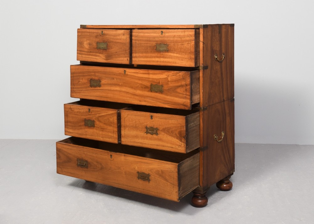 A two-part 19th-century camphor wood campaign chest featuring flush brass corners, recessed brass handles, and turned bun feet. View II