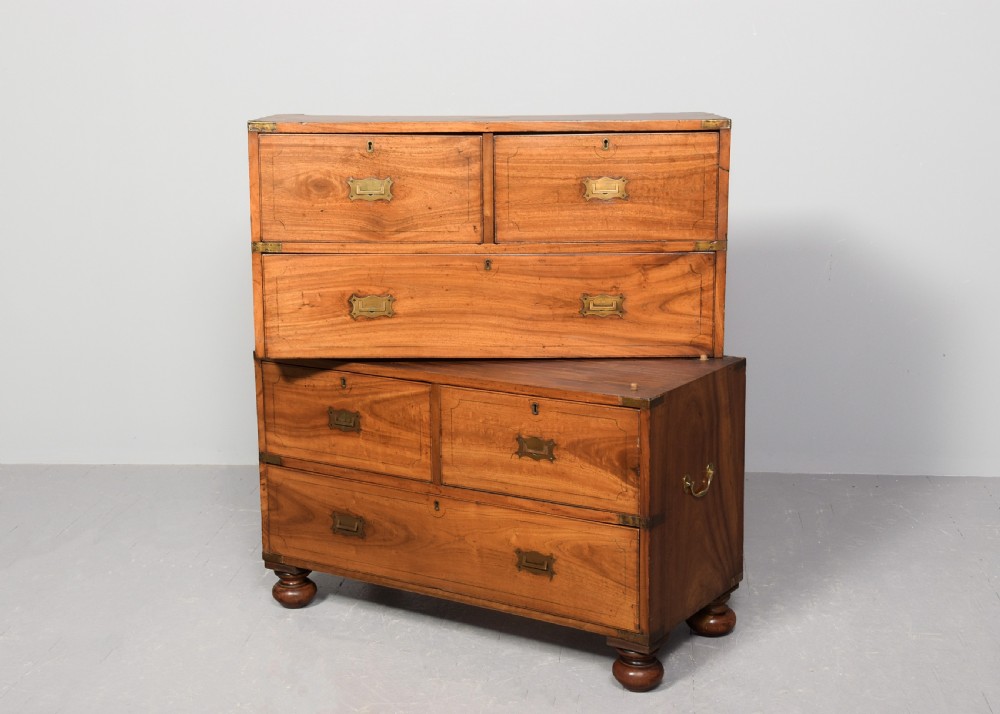 A two-part 19th-century camphor wood campaign chest featuring flush brass corners, recessed brass handles, and turned bun feet. View IX