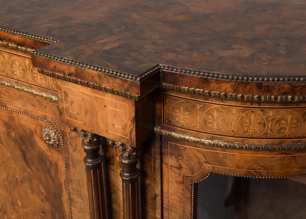 A Victorian burr walnut credenza featuring curved glazed end display sections, twin central cupboard doors decorated with blue Jasperware plaques, and gilt metal mounts. View III