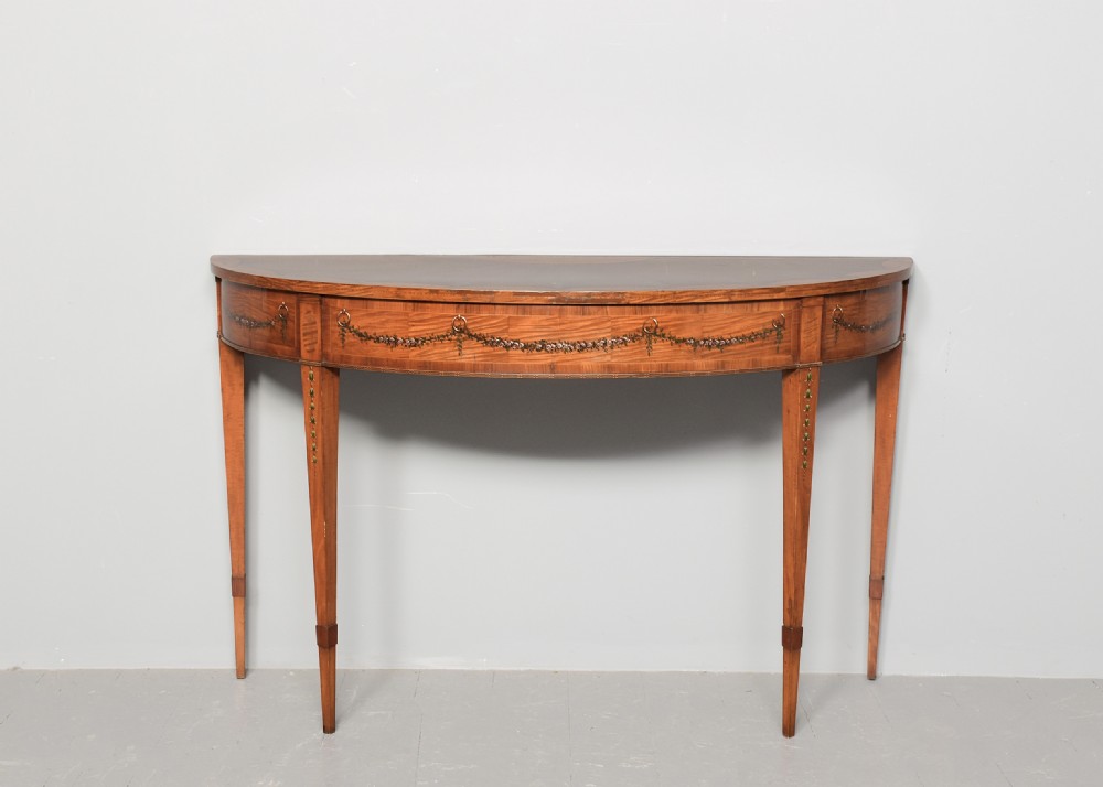 A George III semi-circular satinwood serving table with painted floral garlands along the apron and tapered legs. View V
