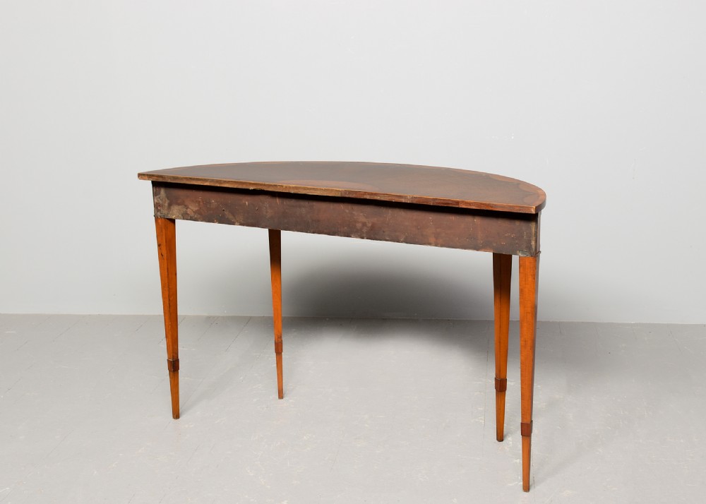 A George III semi-circular satinwood serving table with painted floral garlands along the apron and tapered legs. View VII