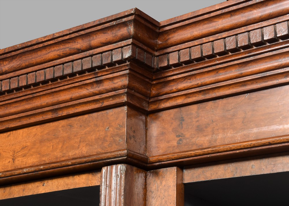 A tall Victorian breakfront open bookcase in pollard oak featuring three sections and grey painted backboards. View V