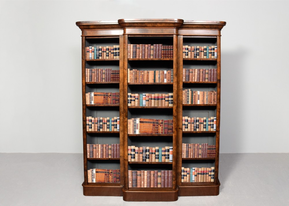 A mid-Victorian burr walnut breakfront open bookcase featuring three bays with adjustable shelves and a moulded cornice. View II
