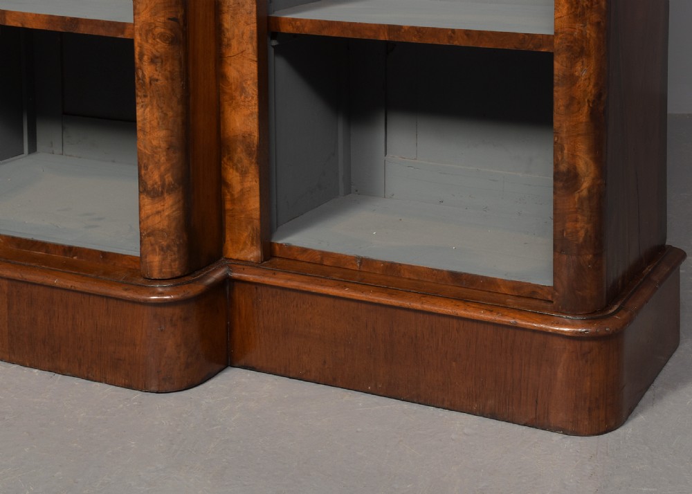 A mid-Victorian burr walnut breakfront open bookcase featuring three bays with adjustable shelves and a moulded cornice. View IV