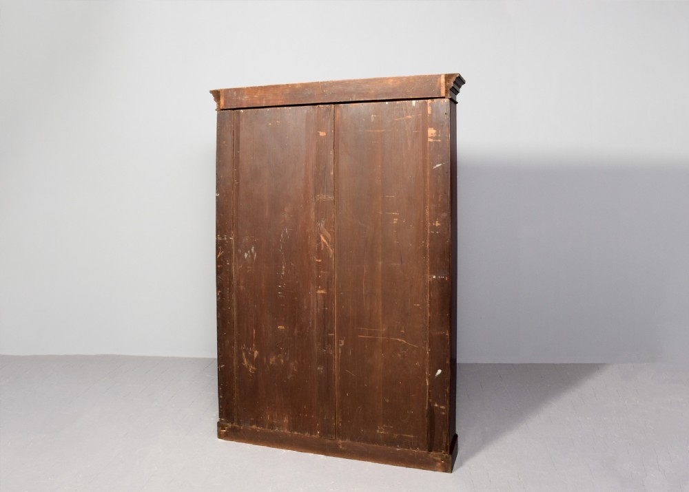 A tall Victorian mahogany open bookcase featuring a moulded cornice, six open shelves, and a grey painted back panel. View VII