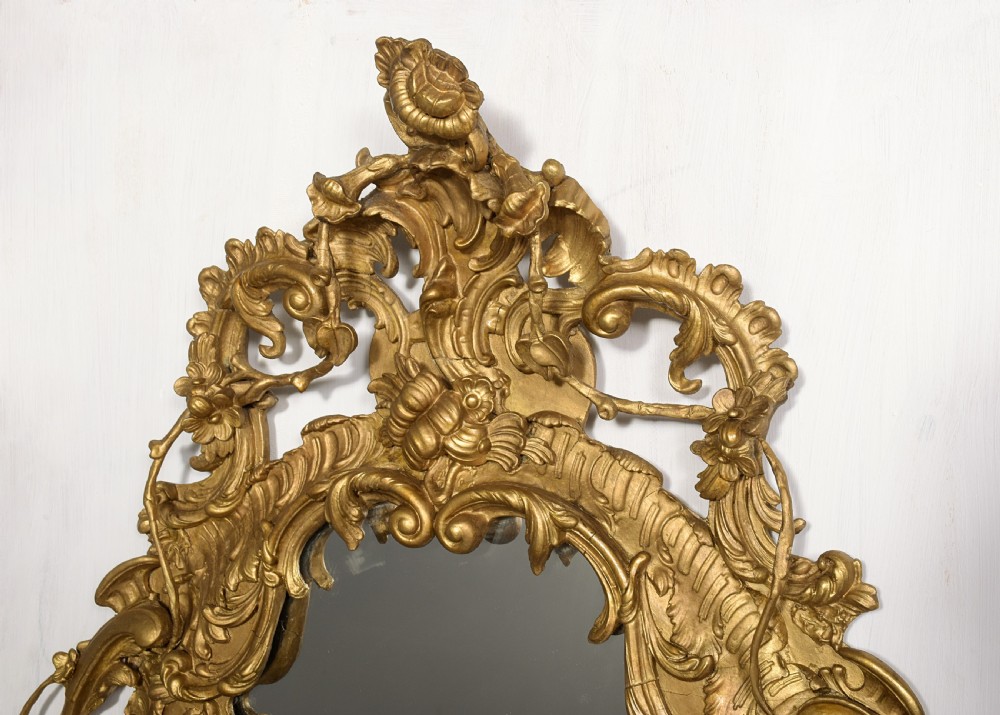 An ornate carved gilded frame featuring Rococo scrollwork, acanthus leaves, integrated candle branches, and two mirror sections. View II