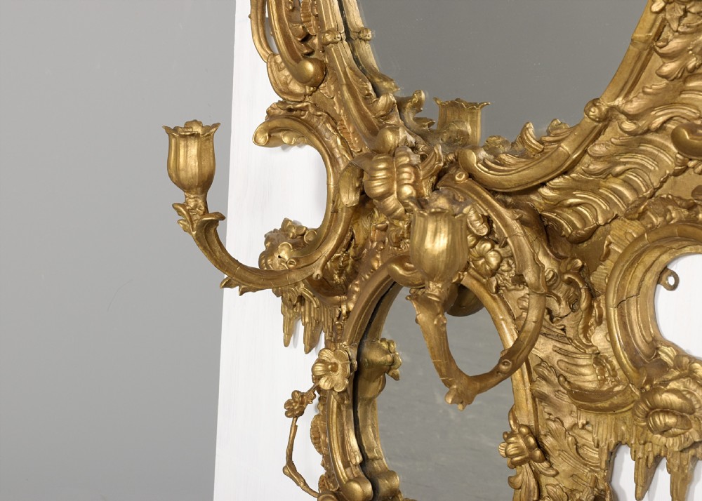 An ornate carved gilded frame featuring Rococo scrollwork, acanthus leaves, integrated candle branches, and two mirror sections. View IV