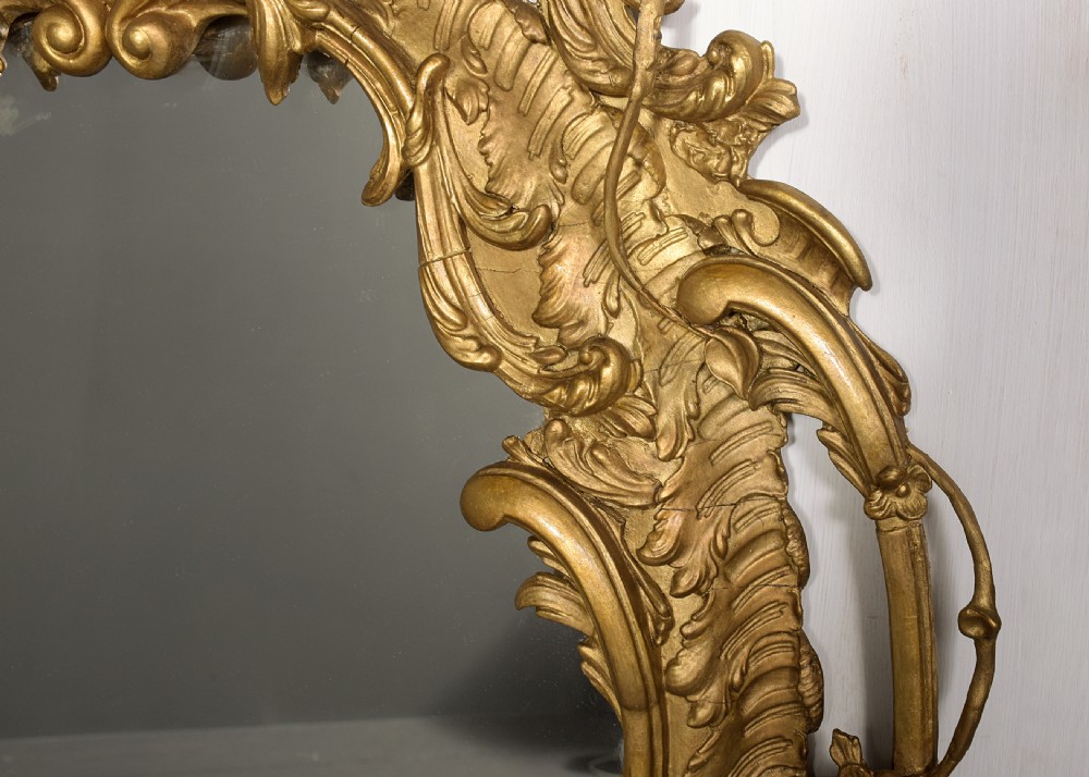 An ornate carved gilded frame featuring Rococo scrollwork, acanthus leaves, integrated candle branches, and two mirror sections. View VII