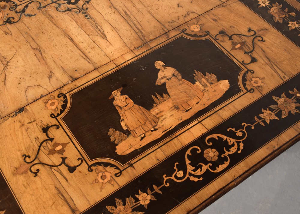 An Italian Sorrento olivewood sofa table featuring intricate marquetry figure inlays, drop-leaf side flaps, two drawers, and barley twist legs connected by a turned stretcher. View VII