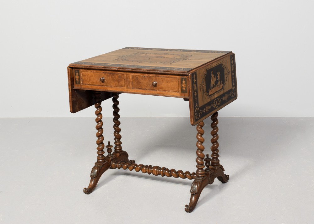 An Italian Sorrento olivewood sofa table featuring intricate marquetry figure inlays, drop-leaf side flaps, two drawers, and barley twist legs connected by a turned stretcher. View X