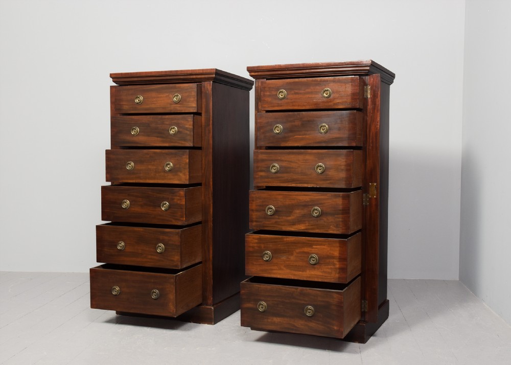 A pair of tall Victorian mahogany Wellington chests, each featuring six graduated drawers with brass handles and side locking stiles set on a plinth base. View III