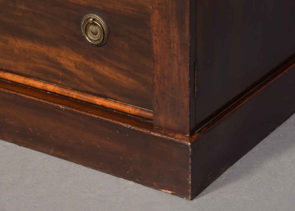 A pair of tall Victorian mahogany Wellington chests, each featuring six graduated drawers with brass handles and side locking stiles set on a plinth base. View IV