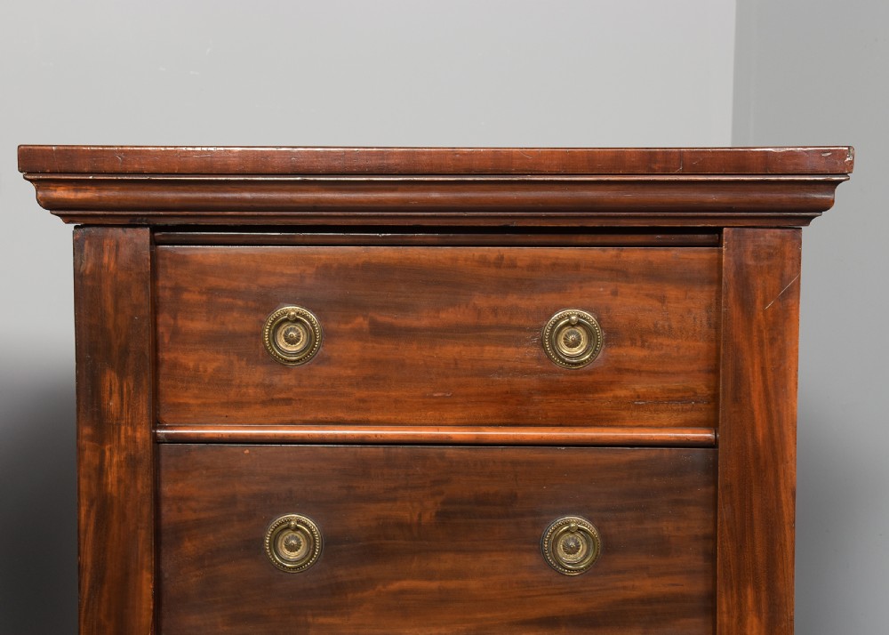 A pair of tall Victorian mahogany Wellington chests, each featuring six graduated drawers with brass handles and side locking stiles set on a plinth base. View VI