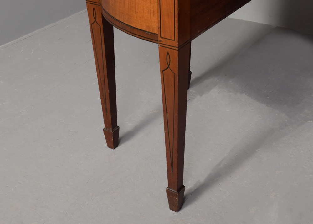 A George III mahogany stage-back sideboard featuring a raised upper tier, oval inlay detailing, brass lion-mask ring pulls, and tapered square legs. View IX