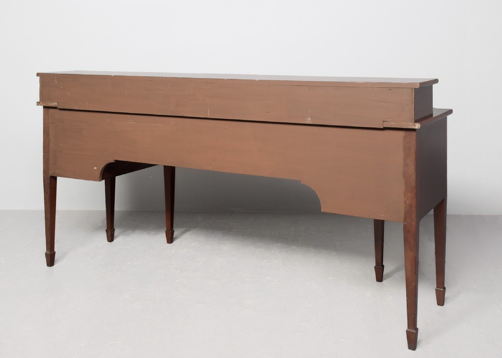 A George III mahogany stage-back sideboard featuring a raised upper tier, oval inlay detailing, brass lion-mask ring pulls, and tapered square legs. View X
