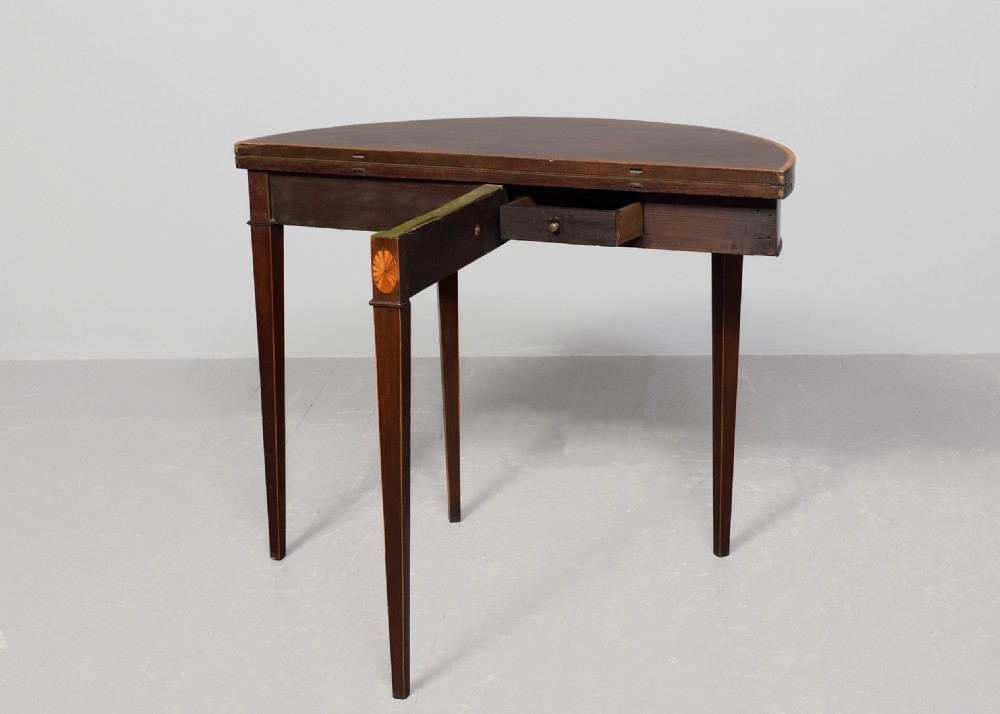 A George III semi-circular mahogany card table with satinwood inlay and square tapered legs. View VII