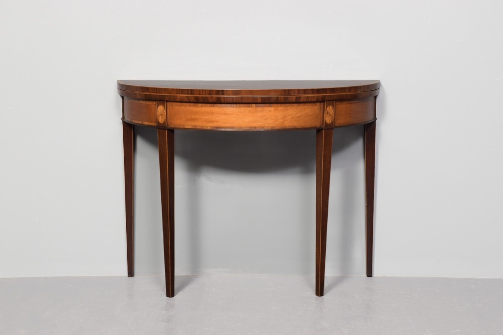 A George III semi-circular mahogany card table with satinwood inlay and square tapered legs. View X