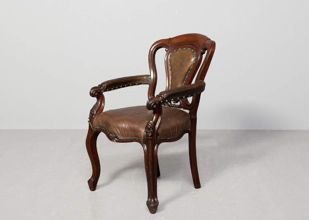 A set of eight Victorian mahogany dining chairs featuring padded leather backs, brass stud detailing, and carved cabriole legs. View III