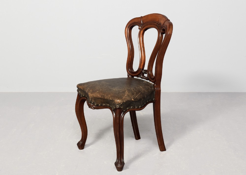 A set of eight Victorian mahogany dining chairs featuring padded leather backs, brass stud detailing, and carved cabriole legs. View IX