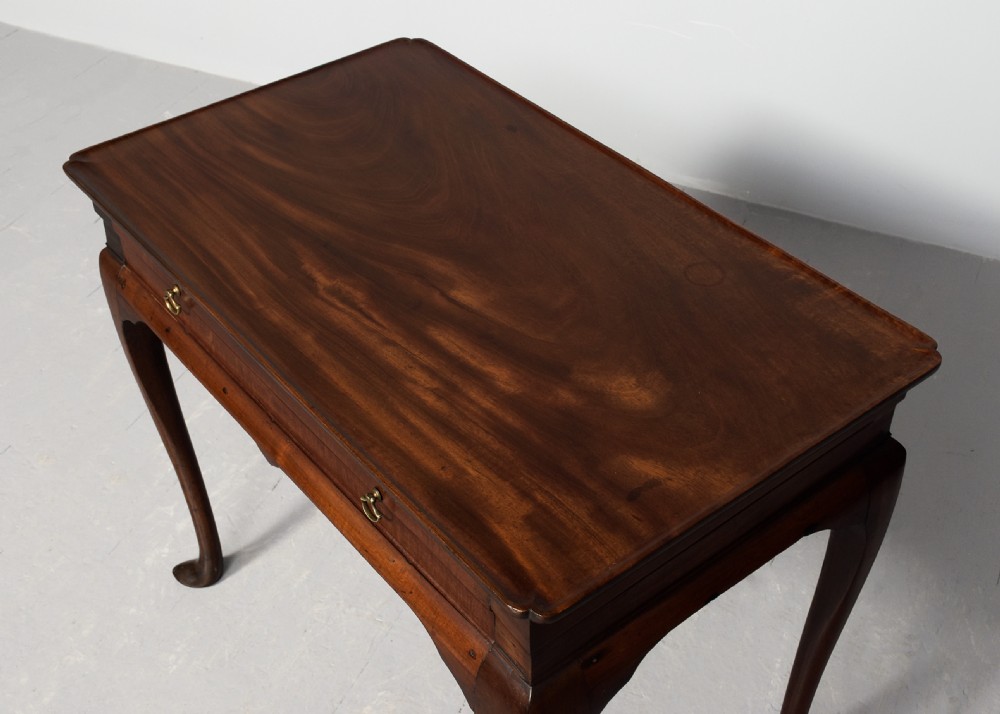 An 18th-century George III mahogany lowboy featuring a single drawer with brass drop handles, a shaped apron, and cabriole legs ending in pad feet. View III