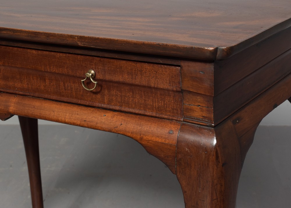 An 18th-century George III mahogany lowboy featuring a single drawer with brass drop handles, a shaped apron, and cabriole legs ending in pad feet. View IV