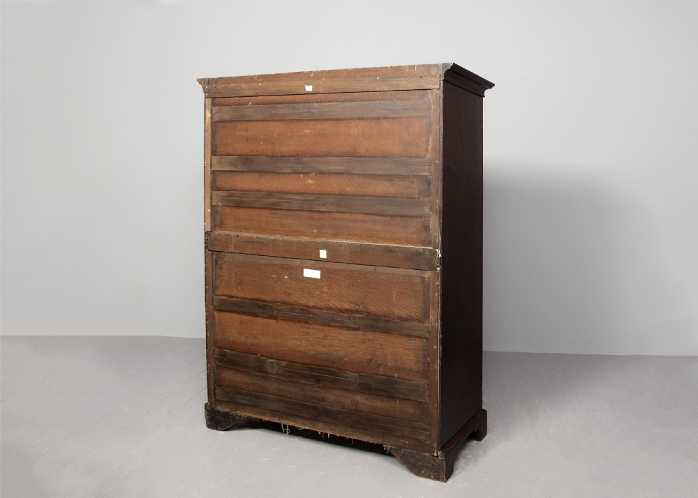 An early George III mahogany press wardrobe featuring two fielded panel doors, a moulded cornice, and bracket feet. View VIII