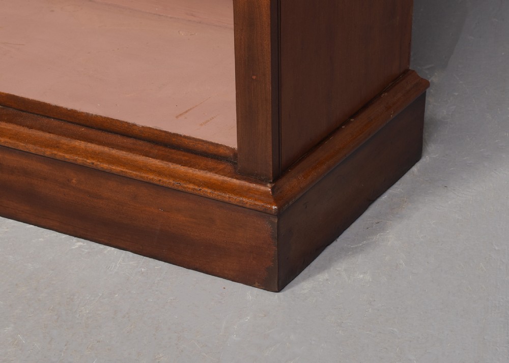 A tall mid-Victorian mahogany open bookcase featuring a double-bay design with adjustable shelves set upon a solid plinth base. View III